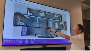 National Purple Heart Honor Mission Executive Director Col. Russ Vernon reviews the design plans for the interior layout of the National Purple Heart Traveling Tribute and Education Center.