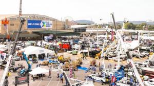 Aerial view of The Utility Expo showcasing utility vehicles, heavy machinery, and equipment exhibits with attendees exploring outdoor booths.