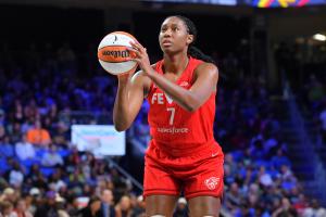 Aliyah Boston of the Indiana Fever stands at the foul line, eyes on the rim, ball in both hands, with the crowd softly blurred behind her.