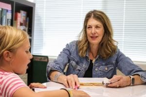 Danielle Costa, founder of Learning Matters in Roseburg, Oregon, works one-on-one with a student to build math and reading fluency through Precision Teaching.