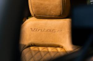 Close-up of a premium leather seat with diamond stitching and the word “Vintage” embossed on the headrest inside a Vintage Modern Classic SUV.