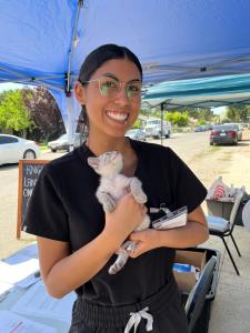 Briana Guerra, a veterinary student, holds a kitten while celebrating her scholarship