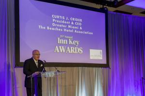 Curtis J. Crider speaking at the 2025 Inn Key Awards in Miami, representing GMBHA’s leadership in hospitality.