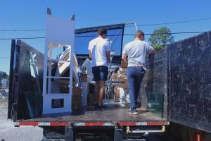 Black Dog Crew at Work Moving Around Items in the Black Dog Junk truck