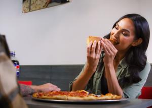Sbarro Guest Enjoying a Slice of Pizza