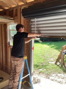 Technician from Ready To Roll Garage Doors completing a spring repair in North Hills, Raleigh NC.