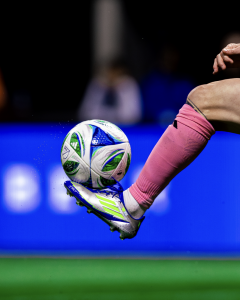Photo of soccer ball and cleat kicking ball in air