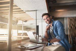 Entrepreneur working on a laptop – representing Hello Funding’s small business financing clients