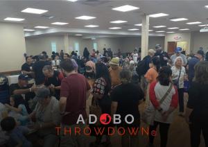 A lively crowd gathers at the Adobo Throwdown food court, savoring authentic Filipino flavors and celebrating community at the heart of the festival.