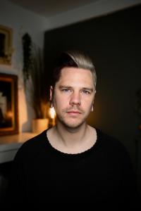 A press photo of tattoo artist Owen Paulls