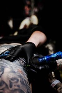 A photo of Owen Paulls tattooing a client