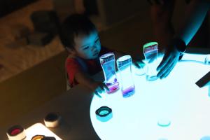 Child playing in light table at Studio B
