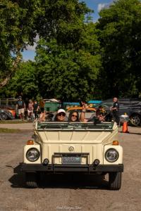 Classic Volkswagen convertible with smiling passengers at the Vintage VW Car Show during Oktoberfest Miami.