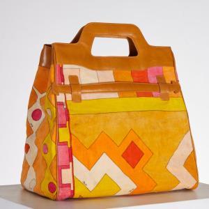 Emilio Pucci bright orange velvet combo piece that can be carried as a tote or fold over style, with leather handle and fastener trim in camel. Estimate: $300-$400.