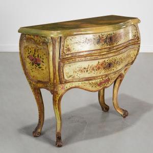 Antique Venetian painted bombe commode with a later faux painted marble top over a green painted and floral decorated case. Estimate: $600-$800.
