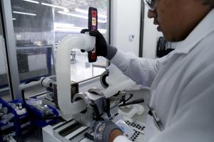 Photo of a technician machining plastics using fusion bonding to prepare materials for deployment in semiconductor fab construction.