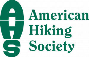 American Hiking Society logo in green text where the acronym AHS is shaped to look like a footprint from a hiking boot and American Hiking Society is spelled out next to it