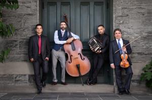 four handsome argentine tango musicians holding their instruments in from of the NC Museum of Art