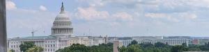 View from the MZLS Washington, D.C. office overlooking the U.S. Capitol and surrounding federal buildings under a partly cloudy sky.