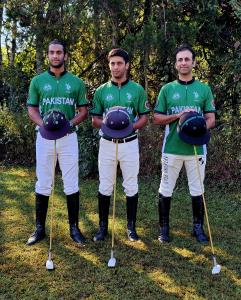 Pakistani arena polo players line up in polo equipment for a team photo