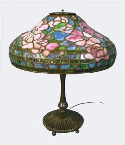 Stunning early 20th-century "Peony" table lamp attributed to Unique Art Glass & Lighting Company with a domed shade executed in richly colored leaded glass. Estimate: $6,000-$18,000.