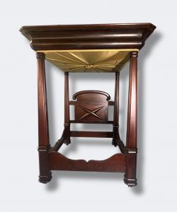 Circa 1840 classical richly grained mahogany tester bed, the boldly stepped canopy supported by four massive turned columnar posts set on square plinth bases. Estimate: $5,000-$15,000.