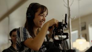 Young filmmaker Lauren Havel looks through a video camera on the set of her movie