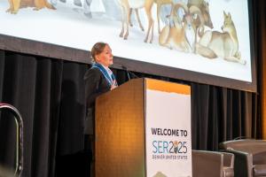 Vera Veranova presenting her keynote presentation: Dream to reality – Restoring the Golden Steppe at scale — Work of the Altyn Dala Conservation Initiative, on day 3 of SER2025.