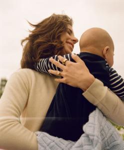 A smiling person holds a baby wrapped in a blanket, symbolizing connection, care, and family well-being—values central to Connect Family Law’s holistic approach.