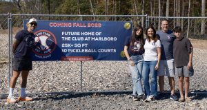 At 414 Texas Road in Marlboro, owners Erica and Mike Rosenberg, their children Hayden and Hunter, and Director of Racquets Igor Silva mark the location of The Club at Marlboro, a new 10-court indoor pickleball facility opening in 2026.