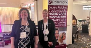 Rosemark team members at a home care conference earlier this year, discussing home care software and EVV compliance.