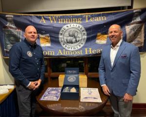 Mike Greenblatt and Tim Kesecker standing in front of a Tailgate Spirits event banner