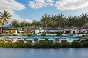 Rendering of a pool area at The Veranda at Indian Springs Calistoga surrounded by palm trees, lounge seating, and Napa Valley scenery. (Keywords: Indian Springs Calistoga, Napa Valley resort, geothermal pool, wellness travel, spa destination)