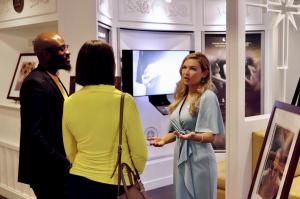 Director of the National Office of Youth for Human Rights discusses the importance of human rights education while giving a tour of the exhibit to two attendees.