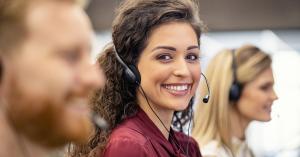 Rosemark customer success team members wearing headsets and providing attentive support in a professional office environment."