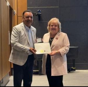 Dr. Hakam Singh Bhullar receiving the Certificate of Recognition from Surrey Mayor Brenda Locke