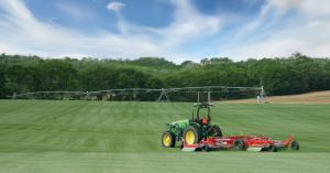 Tractor with Sabanto's autonomous technology mowing a field without a driver.