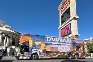 Taiwan Tourism bus advertisement featuring Taipei 101 and the scenic Hehuanshan mountain landscape.