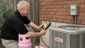 One of Adam's Air Systems service specialists working outside a client's home.
