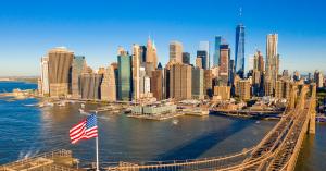 New York City skyline and bridge at sunset, symbolizing the EB-5 Investor Visa pathway to U.S. residency and opportunity.