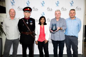 Nigel Biggs receives Queen's Award in the presence of Richard Kornicki and Rupa Huq MP