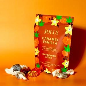 Jolly Cannabis 1:1 THC:CBD 15MG Taffies Caramel Vanilla on an orange background from Jolly Cannabis instagram page