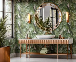 Luxurious bathroom interior featuring Casamonte tropical leaf wallcovering, modern gold-framed mirror, and wood vanity with natural greenery accents.