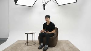 Close-up shot of Austin KOO, CEO of Airet, speaking passionately during a studio interview. He is seated on a sofa against a white backdrop.