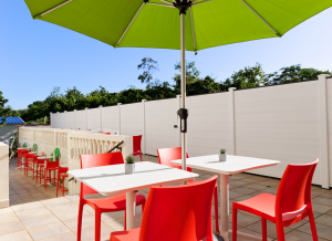 sunny outdoor area with tables and umbrellas