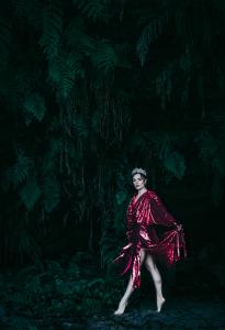 EMPRESS looks ethereal walking through the forest in heels and adorned with a crown.