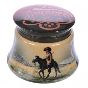 Tobacco humidor marked Nakara in the rare Buffalo Bill Cody scenic décor having green, brown and cream tones with “Tobacco” labeled on the lid, 5 ½ inches tall. Estimate: $1,500-$2,500.