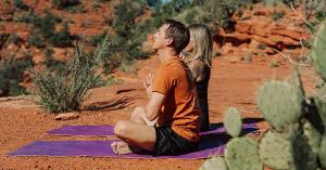A couple takes part in a daily yoga session with Saha Yoga Sedona.