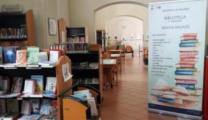 Interior of a library with table and shelves of books