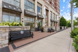 Front entrance and landscaped gardens of Walden Circle Retirement Community on a sunny day.